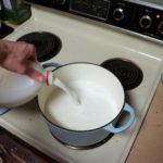 Pouring the milk into the dutch oven